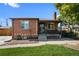 Brick ranch home with a landscaped lawn and a covered porch at 4747 Shoshone St, Denver, CO 80211