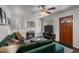 Living room with fireplace, green couch, and hardwood floors at 4747 Shoshone St, Denver, CO 80211