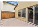 An outdoor patio features stone pavers and a wooden fence with the house and backyard view at 10044 Martin Luther King Blvd, Denver, CO 80238