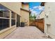 An outdoor patio features stone pavers and a wooden fence with the house and backyard view at 10044 Martin Luther King Blvd, Denver, CO 80238