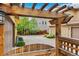 Inviting backyard featuring a pergola, a fence, a garage, and a paved driveway leading to the house at 10044 Martin Luther King Blvd, Denver, CO 80238