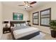 A furnished bedroom with ceiling fan and two windows with wooden shutters at 10044 Martin Luther King Blvd, Denver, CO 80238