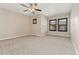 Bright and airy bedroom with neutral carpet, ceiling fan and two windows with shutters at 10044 Martin Luther King Blvd, Denver, CO 80238