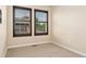 Cozy bedroom featuring carpeted floors and two windows with shutter-style blinds for natural light at 10044 Martin Luther King Blvd, Denver, CO 80238