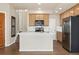Bright kitchen with island, stainless appliances, wood floors and ample storage space at 10044 Martin Luther King Blvd, Denver, CO 80238