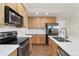 Modern kitchen featuring stainless steel appliances and bright countertops and cabinetry at 10044 Martin Luther King Blvd, Denver, CO 80238