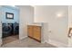 Hallway view of laundry room with front load washer and dryer and cabinet storage at 10044 Martin Luther King Blvd, Denver, CO 80238