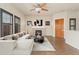 Bright living room with hardwood floors, fireplace, and large windows with plantation shutters at 10044 Martin Luther King Blvd, Denver, CO 80238
