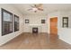 Charming living room featuring a cozy fireplace, hardwood floors, and window shutters at 10044 Martin Luther King Blvd, Denver, CO 80238