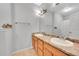 Bathroom featuring dual sinks with a large mirror and wood-look flooring at 15700 E Jamison Dr # 6-201, Englewood, CO 80112