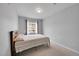 Carpeted bedroom featuring a window with curtains and neutral colored walls at 15700 E Jamison Dr # 6-201, Englewood, CO 80112