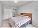 Bright bedroom with carpet, a double bed, and a closet with white doors at 15700 E Jamison Dr # 6-201, Englewood, CO 80112