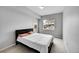 Cozy bedroom featuring a modern bed frame, soft carpeting, and natural light from a window at 15700 E Jamison Dr # 6-201, Englewood, CO 80112