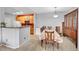 Light-filled dining area featuring a floral tablecloth and seamlessly connecting to the kitchen at 15700 E Jamison Dr # 6-201, Englewood, CO 80112