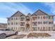 Exterior view of condo building showing symmetrical design, balconies, and stairs to the upper floors at 15700 E Jamison Dr # 6-201, Englewood, CO 80112