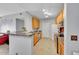 Well-lit kitchen with stainless steel appliances, wooden cabinets and a breakfast bar with a double sink at 15700 E Jamison Dr # 6-201, Englewood, CO 80112