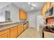 Bright kitchen featuring wooden cabinets, stainless steel appliances and a double sink with a breakfast bar at 15700 E Jamison Dr # 6-201, Englewood, CO 80112