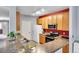 Well-lit kitchen with stainless steel appliances, wooden cabinets and a double sink with a window view at 15700 E Jamison Dr # 6-201, Englewood, CO 80112