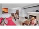 Inviting living room features a cozy fireplace and seamlessly connects to the dining area at 15700 E Jamison Dr # 6-201, Englewood, CO 80112