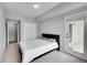 Carpeted main bedroom with a walk out balcony, a closet and neutral colored walls at 15700 E Jamison Dr # 6-201, Englewood, CO 80112