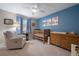 Serene Bedroom with glider, crib, changing table, and calming blue accent wall at 7583 S Xanthia Ct, Centennial, CO 80112