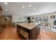 Open concept kitchen with central island and stainless steel appliances, flowing into a cozy living space at 7583 S Xanthia Ct, Centennial, CO 80112