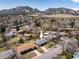 Charming home shown from an aerial view, set amidst a leafy neighborhood with stunning mountain backdrop at 1275 Berea Dr, Boulder, CO 80305