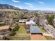 Aerial view of the neighborhood featuring the house, lush green trees, and stunning mountain views at 1275 Berea Dr, Boulder, CO 80305