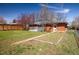Spacious backyard with a small deck, well-maintained lawn, and beautiful landscaping at 1275 Berea Dr, Boulder, CO 80305