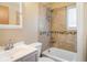 Tiled bathroom featuring a shower-tub combo and a modern vanity at 1275 Berea Dr, Boulder, CO 80305