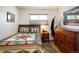 Comfortable bedroom featuring hardwood floors and a wooden dresser at 1275 Berea Dr, Boulder, CO 80305