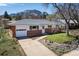 Charming single-story home with brick accents, well-manicured lawn, and mountain views at 1275 Berea Dr, Boulder, CO 80305