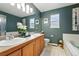 Bathroom featuring a vanity with double sinks, tiled floors, and tub at 2574 Cove Creek Ct, Highlands Ranch, CO 80129