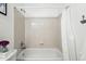 Bright bathroom with a standard tub, tiled walls, and neutral color scheme at 2574 Cove Creek Ct, Highlands Ranch, CO 80129