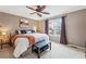 Cozy bedroom featuring a large window, ceiling fan, and a cushioned bench at 2574 Cove Creek Ct, Highlands Ranch, CO 80129
