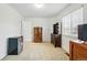 Carpeted bedroom with natural light, wooden furniture, and a convenient mini-fridge at 2574 Cove Creek Ct, Highlands Ranch, CO 80129