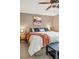 Bedroom features a bed with an upholstered headboard and side tables with lamps at 2574 Cove Creek Ct, Highlands Ranch, CO 80129
