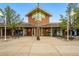 Community clubhouse boasting brick exterior, glass-lined entry, and well-maintained landscaping at 2574 Cove Creek Ct, Highlands Ranch, CO 80129