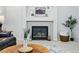 Living room fireplace featuring mantle decor and tile surround at 2574 Cove Creek Ct, Highlands Ranch, CO 80129