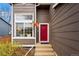 Stylish red front door and large window enhance the curb appeal of this charming home at 2574 Cove Creek Ct, Highlands Ranch, CO 80129