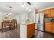Open concept kitchen with stainless appliances, wood floors, dining area and backyard views at 2574 Cove Creek Ct, Highlands Ranch, CO 80129