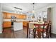 Kitchen and dining area featuring stainless appliances, wood floors, and a sliding glass door to the backyard at 2574 Cove Creek Ct, Highlands Ranch, CO 80129
