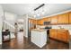 Bright kitchen features stainless steel appliances, wooden cabinets, and an island with hanging lights at 2574 Cove Creek Ct, Highlands Ranch, CO 80129