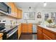 Charming kitchen area with stainless appliances, dark hardwood floors, and a door to the backyard at 2574 Cove Creek Ct, Highlands Ranch, CO 80129