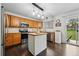 Bright kitchen offers stainless appliances, hardwood floors, and a center island with white finish at 2574 Cove Creek Ct, Highlands Ranch, CO 80129