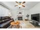 Bright living room features a tiled fireplace, ceiling fan, and comfortable seating at 2574 Cove Creek Ct, Highlands Ranch, CO 80129