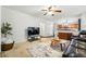 Open-concept living room featuring carpet floors, ceiling fan, and seamless kitchen view at 2574 Cove Creek Ct, Highlands Ranch, CO 80129
