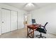 Well-lit office space with a computer setup and convenient access to a nearby closet at 2574 Cove Creek Ct, Highlands Ranch, CO 80129
