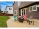Outdoor patio with colorful chairs arranged around a fire pit for relaxed gatherings at 2574 Cove Creek Ct, Highlands Ranch, CO 80129