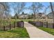 Picturesque walking path featuring a charming bridge and views of nearby homes at 2574 Cove Creek Ct, Highlands Ranch, CO 80129